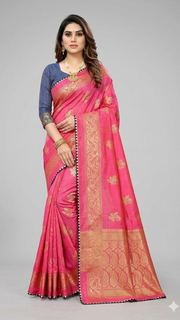 Woman wearing a pink saree with gold patterns on a gray background