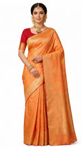 Woman wearing an orange saree with a red blouse on a white background