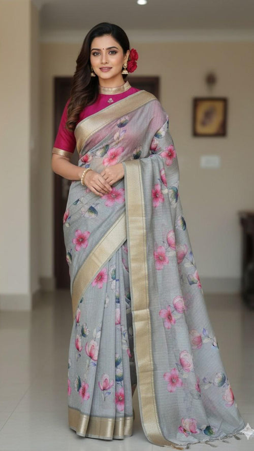 Woman wearing a gray floral sari with a pink blouse in an indoor setting